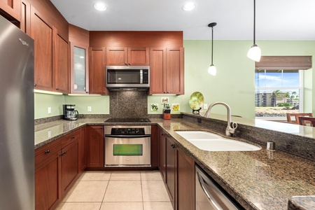 Full kitchen with breakfast bar, granite counters, and stainless steel appliances