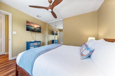 Sink into crisp linens and let the ceiling fan's gentle breeze lull you to sleep. Your restful retreat features warm tones, ample storage, and everything you need to unwind.