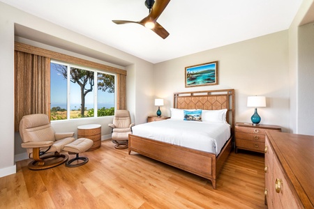 - Spacious bedroom with king bed wood frame and matching nightstands for a cohesive look - Large window frames ocean views and fills the room with abundant natural light - Cozy recliner and ottoman create a perfect reading or relaxation corner