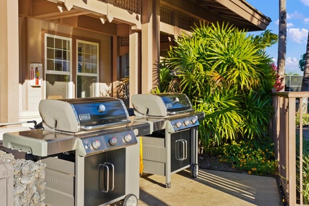 Outdoor grills ready for your cookout, surrounded by tropical greenery and just steps from your door.