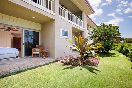 - Ground level patio with seating overlooks a manicured lawn and gardens   - Tropical landscaping adds vibrant greenery and island inspired charm   - Easy access to indoor spaces through sliding glass doors for relaxation