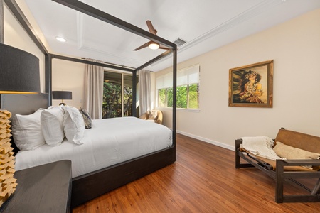 Drift into blissful sleep in your elegant canopy bed, surrounded by warm hardwood floors and garden views through expansive windows.