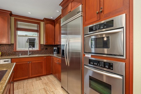 Your gourmet kitchen features rich cherry cabinetry and top-tier stainless steel appliances, making meal prep a pleasure during your stay.