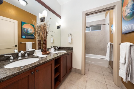 Guest bathroom with double vanity and shower / tub combo