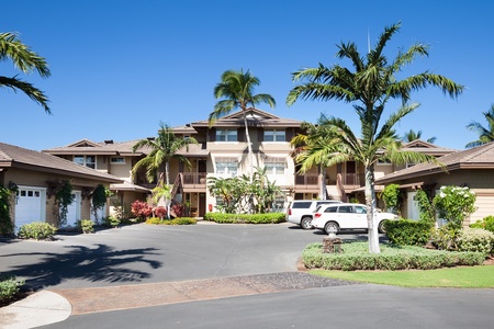 Tropical style complex with extra parking and vibrant landscaping.