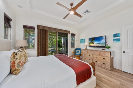 Drift off to sleep in this serene bedroom with tropical touches, featuring a plush king bed and private balcony access.