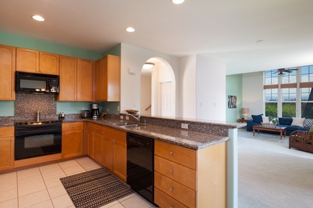 - Spacious kitchen with granite countertops, full size appliances, and tons of prep space - Coffee maker and all essentials make mornings easy and convenient - Arched doorway leads to the rest of the home with living areas just steps away