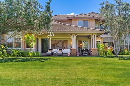 Back patio with outdoor seating opening onto a grassy lawn.