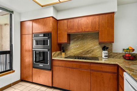 Cook like a chef in your gourmet kitchen featuring rich wood cabinetry, granite countertops, and premium appliances perfect for culinary adventures.