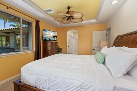 Stretch out in a king size bed under a tropical fan.