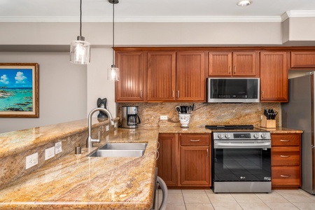 Your fully equipped kitchen features granite countertops, stainless steel appliances, and warm wood cabinetry for effortless meal preparation.