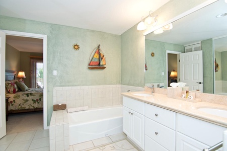 - Refresh in a bright bathroom with a deep soaking tub and decorative nautical wall art   - Large vanity with dual mirrors provides space for your essentials and morning routine   - Soft lighting adds warmth to the room’s airy and coastal inspired design