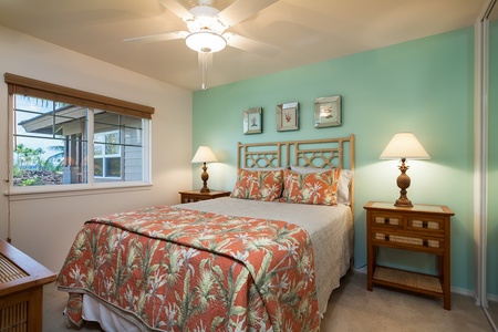 - Queen bedroom with tropical coral bedding and soft seafoam walls for a soothing vibe - Dual lamps and charming nightstands frame the bed for cozy evening reads - Island style artwork and natural tones complete this peaceful retreat