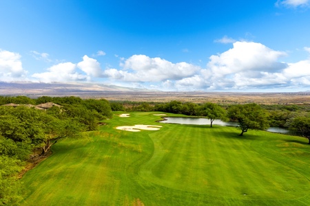 Panoramic view of the pristine golf course and pond.