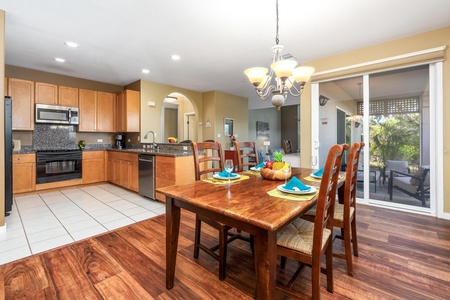 Gather around this warm, inviting dining space where your group can share meals together. The fully equipped kitchen flows seamlessly into the dining area, while sliding doors open to your private screened patio.