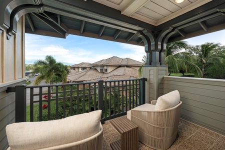 Unwind on your private covered balcony with comfortable seating and tropical views of the lush neighborhood below.