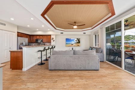 Your open-concept living space flows seamlessly from kitchen to lounge, with soaring ceilings and tropical touches creating the perfect Hawaiian retreat.