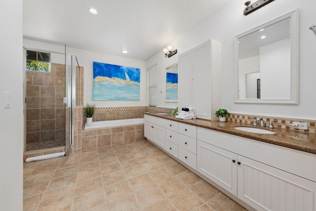 Unwind in your luxurious master bathroom featuring a soaking tub, spacious glass shower, and elegant granite counters for your daily retreat.