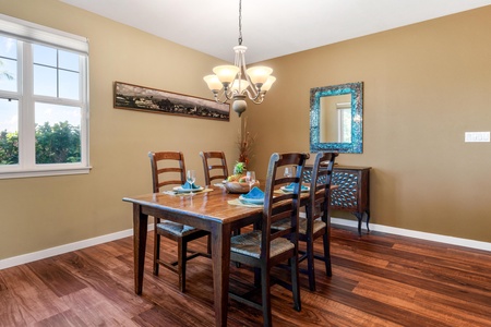 Gather around the elegant dining table with comfortable seating for six, where warm wood tones and natural light create the perfect setting for your family meals together.