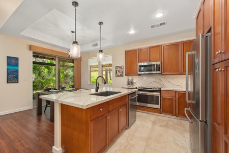 Your gourmet kitchen features rich wood cabinetry, elegant marble countertops, and premium stainless appliances for memorable meal preparation.