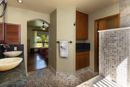 Bathroom features plenty of storage, and tiled floors.