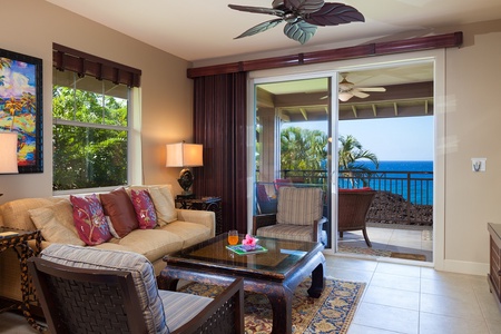 - Relax indoors while still enjoying the ocean through large sliding doors to the lanai - Cozy couch, patterned pillows, and natural textures invite you to unwind in style - Let the tropical breeze flow through as you lounge and recharge