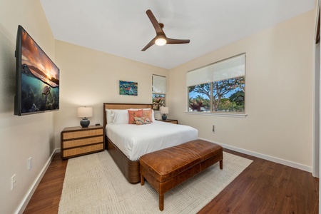 Wake up refreshed in your serene bedroom with modern furnishings, smart TV entertainment, and peaceful garden views through large windows.