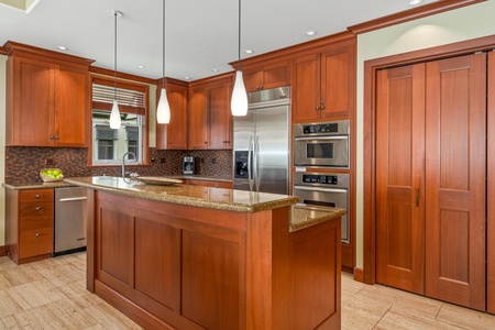 Your gourmet kitchen awaits with rich wood cabinetry, granite countertops, stainless appliances, and a spacious island for cooking and gathering together.
