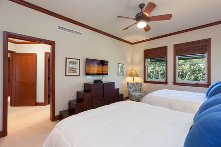 - Bedroom features two comfortable beds, a flat screen TV, and cozy seating by the window - Rich wood trim and furniture add warmth to the inviting space - Ensuite bathroom access for convenience during your stay
