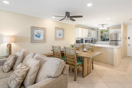 - Cozy up for family meals or board games at this island style dining setup - Warm wood table, ceiling fan, and art prints create a relaxed tropical feel - Enjoy seamless flow from kitchen to dining to lounging under one roof