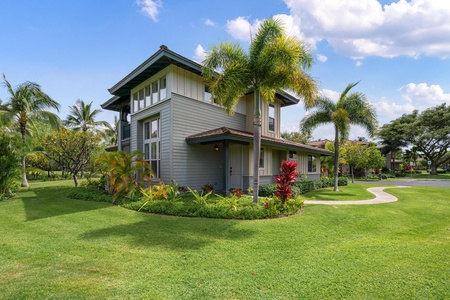 Modern tropical villa nestled among swaying palms and vibrant gardens in a peaceful resort setting.