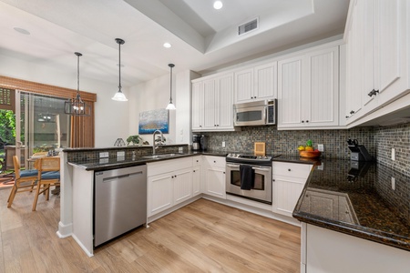 Your spacious kitchen features granite countertops, stainless appliances, and elegant pendant lighting—perfect for preparing memorable meals together.