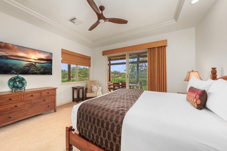 Wake up in your serene master bedroom with lush garden views, crisp linens, and tropical breezes from your ceiling fan.