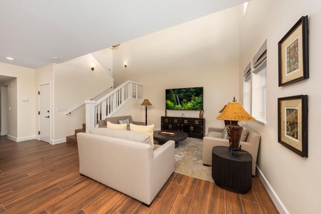 Unwind in your spacious living room with plush seating, warm hardwood floors, and thoughtful decor creating the perfect retreat.