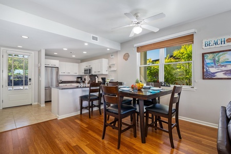 - Enjoy meals by the window with sunlight streaming in over hardwood floors - Open dining space flows into a sleek kitchen with bar seating and lighting - Perfect for breakfast feasts or group dinners in a relaxed setting