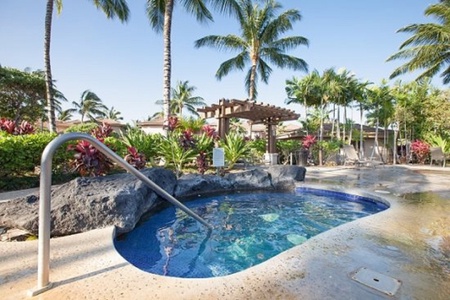 Tranquil hot tub nestled among tropical landscaping and lava rock.