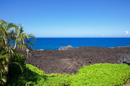 Unobstructed view of the deep blue ocean beyond striking lava fields.