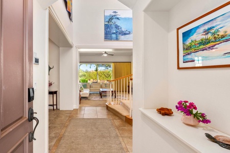 - Welcome inside with tile floors, floral touches, and local art decor - This entry hallway leads you into the heart of the home with a view - Bright space with a coastal feel sets the tone for your island retreat