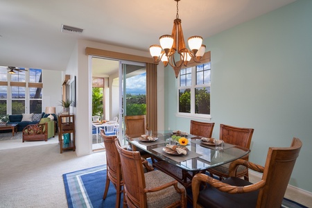 - Elegant glass top dining table seats six comfortably under a warm chandelier glow - Large windows and nearby sliding doors bring light and garden views - Perfect for sit down meals, board games, or sunset gatherings indoors