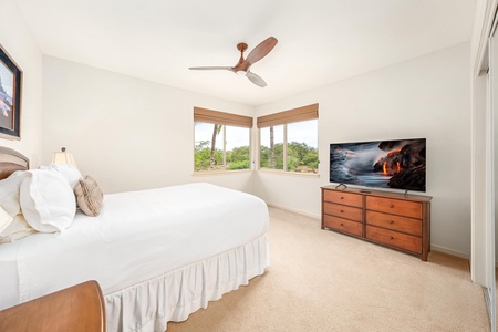 Wake up to tropical greenery through your corner windows while crisp white linens and warm wood tones create your peaceful retreat.