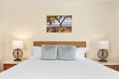Sink into crisp white linens and plush pillows after your island adventures, with coastal artwork inspiring dreams of tomorrow's beach discoveries.