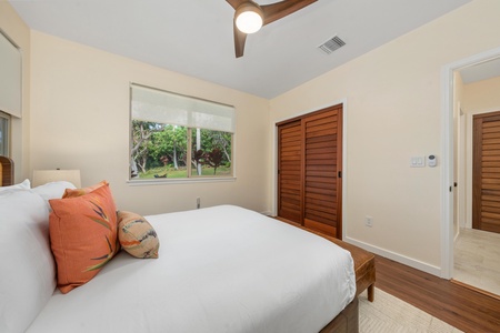 Rest peacefully in your bright bedroom with garden views and elegant wood details creating the perfect tropical retreat.