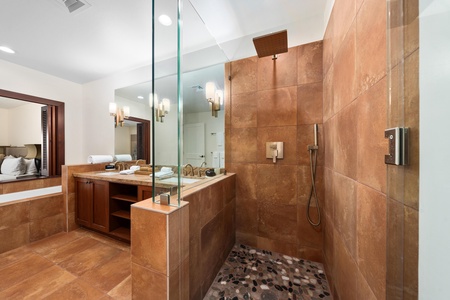 Indulge in your private spa-like bathroom with elegant stone finishes, rainfall shower, and luxurious soaking tub for pure relaxation.