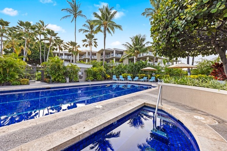 A vibrant blue swimming pool and spa area offering a tranquil retreat.
