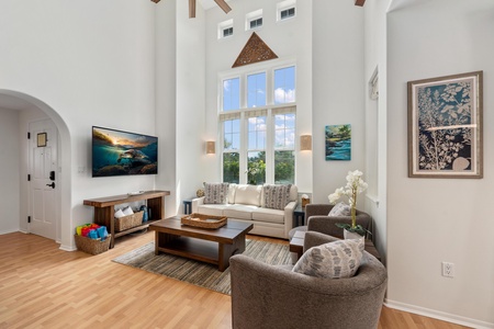 Tall ceilings and towering windows fill this living room with natural light.