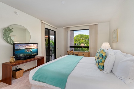 Your serene bedroom features a plush king bed, flat-screen TV, and sliding doors to your private balcony with garden views.