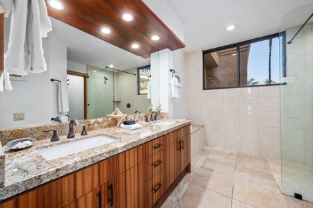 Step into your luxurious ensuite bathroom featuring dual granite vanities, a spacious walk-in shower, and warm wood accents that create a spa-like retreat.