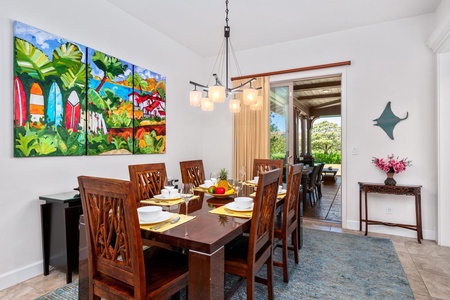 - Set for eight, the elegant dining table is ideal for shared meals - Large sliding glass doors open to the patio and tropical views - Colorful artwork and soft lighting create a warm dining ambiance