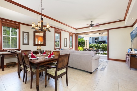 - Dining area set for four with warm wood furnishings and soft lighting   - Open floor plan flows into living space and patio for easy entertaining   - Ideal for family dinners or celebratory meals with friends