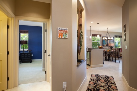 - View from the hallway reveals the home's open layout, with kitchen and living areas straight ahead - Warm tones and subtle decor guide the way to your private bedrooms - Thoughtful design makes it easy to navigate and feel right at home